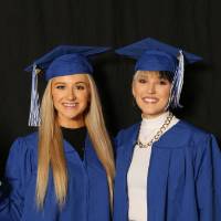 two students using foam finger at photobooth